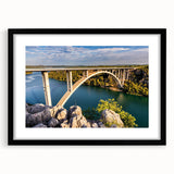 Framed landscape wall art featuring a scenic bridge design with a black mat, showcasing intricate details and vibrant colors, perfect for home décor.