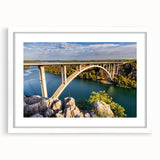 Framed wall art collection showcasing a serene landscape bridge design, featuring a white mat and sleek frame, perfect for enhancing home decor aesthetics.