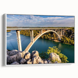 Framed canvas art showcasing a serene landscape with a bridge, designed in a modern aesthetic. The artwork features soft colors and a white frame, perfect for home decor.