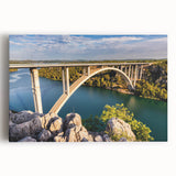 Stretched canvas artwork showcasing a vibrant landscape bridge design with rich colors, ideal for home decor, adding depth and artistic flair to any space.