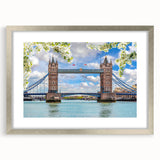 Framed wall art collection showcasing a scenic landscape with a bridge, featuring a sleek silver frame and mat, perfect for home decor enhancement.