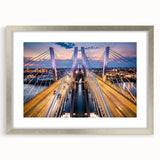 Framed wall art featuring a scenic landscape bridge design with a silver mat, ideal for home decor. The artwork showcases vibrant colors and intricate details, enhancing any room's aesthetic appeal.