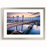 Framed wall art depicting a serene landscape with a bridge, featuring a silver mat and sleek design, perfect for enhancing home decor. Ideal for nature lovers seeking elegant wall accents.