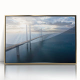 Framed acrylic wall art depicting a scenic landscape with a bridge, featuring vibrant colors and a gold frame, perfect for home decor. This elegant piece enhances any room's ambiance with its artistic charm and rich visual detail.