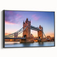Framed wall art of a serene landscape featuring a bridge over a tranquil river, presented in a sleek black frame, ideal for modern home decor. The artwork captures vibrant colors and detailed scenery, enhancing any interior space with an elegant touch.