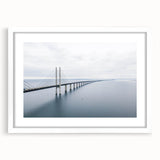 Framed wall art featuring a serene landscape with a bridge, presented in a white mat and sleek frame, ideal for enhancing home decor aesthetics.