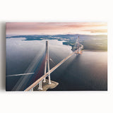 Stretched canvas artwork showcasing a vibrant landscape bridge design, featuring lush greenery and a serene river under a clear blue sky, perfect for home decor.