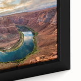 Close-up of a framed canvas print showcasing a vibrant desert canyon landscape, featuring rich reds and oranges, perfect for modern home decor.