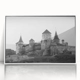 Framed wall art featuring a serene landscape with a castle, displayed in a sleek white frame, highlighting intricate details and vibrant colors, perfect for home decor.