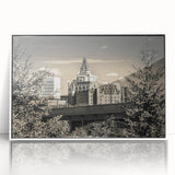 Framed wall art showcasing a vibrant landscape with a majestic castle set against a serene blue sky, featuring a white frame that enhances the artwork's elegance.