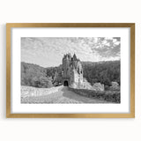 Elegant wall art featuring a gold-framed landscape of a majestic castle, complete with a mat surrounding the artwork, ideal for enhancing home decor and creating a regal ambiance.