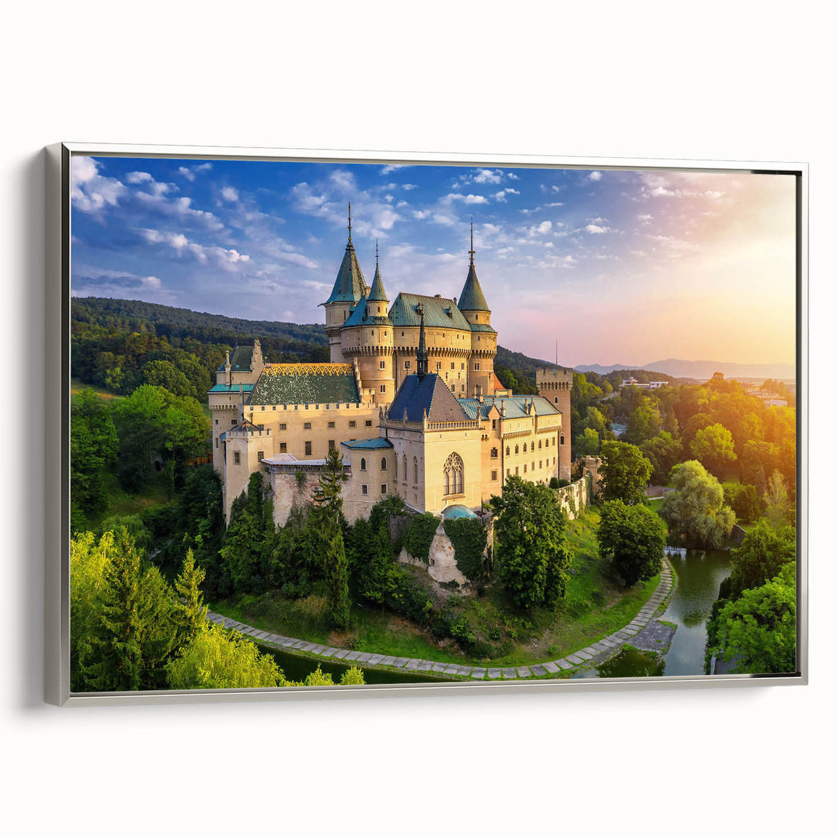 Framed landscape wall art featuring a majestic castle design, elegantly displayed with a silver frame. The canvas showcases rich colors and intricate details, perfect for enhancing home decor. Ideal for those seeking to add a touch of sophistication to their living space.