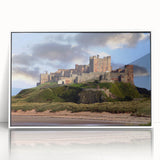 Framed wall art featuring a vibrant landscape of a majestic castle surrounded by lush greenery, showcased in a sleek white frame, ideal for home decor.