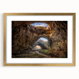 Framed wall art featuring an elegant cave landscape design, presented in a gold frame with a white mat, perfect for enhancing home decor.