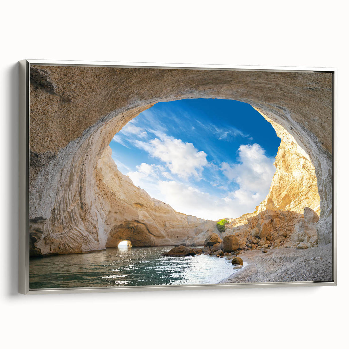 Framed canvas wall art showcasing a serene landscape with intricate cave designs, featuring a silver frame that enhances its elegance, perfect for home decor.