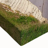 Close-up of a stretched canvas wall art design featuring vibrant landscapes and cliffs, showcasing intricate details and rich colors ideal for home decor.