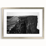 Framed wall art featuring a stunning landscape of cliffs, accented with a silver mat, perfect for enhancing modern home décor. The artwork showcases vibrant colors and intricate details, ideal for adding a touch of elegance to any room setting.