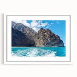Framed landscape wall art depicting dramatic cliffs and serene skies, featuring a white mat and sleek black frame, perfect for modern home decor.