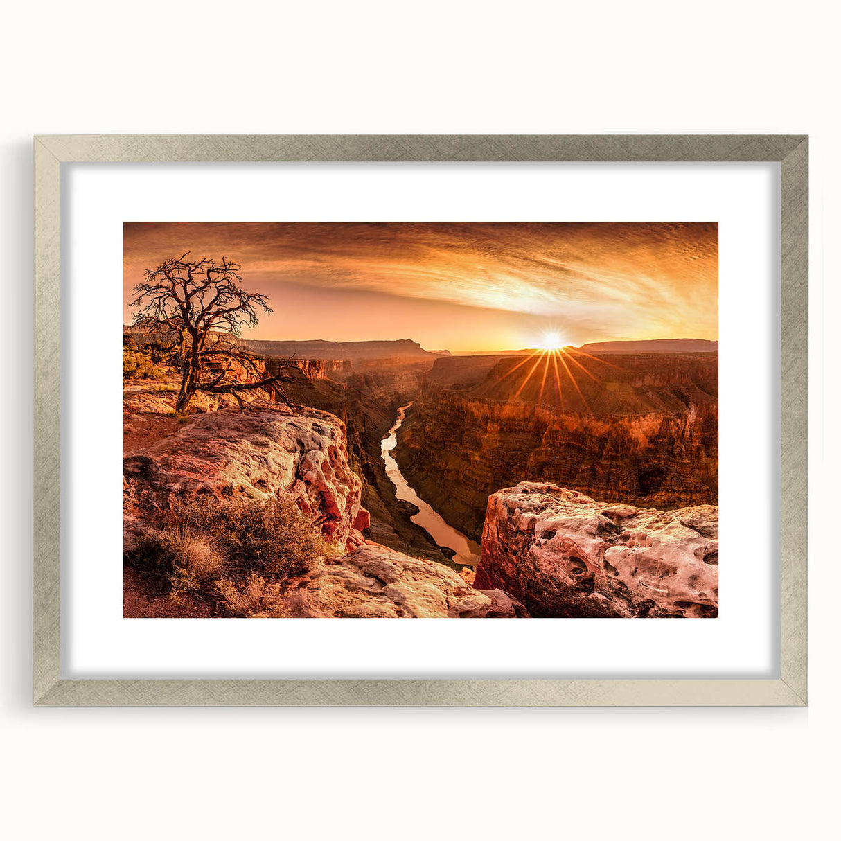 Framed wall art showcasing a serene landscape of cliffs and mountains in muted earth tones, featuring a silver mat and contemporary design for elegant decor.