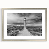 Framed landscape wall art featuring dramatic cliffs with a silver mat and frame, perfect for modern home decor. Elevate your living space with this stunning piece.