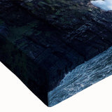 Close-up of a stretched canvas wall art piece showcasing a vibrant landscape of rugged cliffs and serene skies, perfect for enhancing modern home decor.