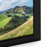 Framed canvas wall art showcasing a serene countryside landscape with vibrant green fields and a blue sky, ideal for home decor and nature enthusiasts.