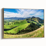 Framed canvas wall art showcasing a serene countryside landscape with vibrant green fields and a golden sunset, designed to enhance any living space decor.