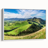 Framed canvas wall art showcasing a serene countryside landscape design, featuring lush green fields and a soft blue sky, perfect for home decor.