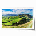 Rolling countryside landscape wall art print showcasing vibrant green fields, a blue sky, and distant hills, designed as a decorative piece for home interiors.