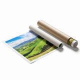 Vibrant rolled print of a serene countryside landscape featuring rolling hills, lush greenery, and a clear blue sky, perfect for home decor and art enthusiasts.