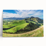 Stretched canvas wall art showcasing a serene countryside landscape with vibrant greens and blues, adding a tranquil touch to home decor. Perfect for nature lovers.