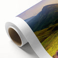 Rolled canvas artwork showcasing a serene countryside landscape with vibrant greenery and rolling hills, elegantly packaged in a protective cardboard tube for easy display.
