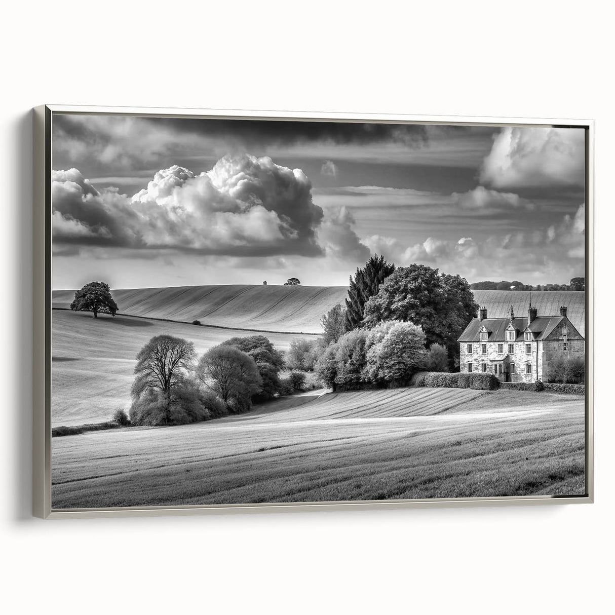 Framed canvas wall art showcasing a serene countryside landscape with vibrant green fields and a clear blue sky, accented by a sleek silver frame, ideal for home decor.
