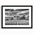 Framed wall art showcasing a serene countryside landscape with vibrant green fields and a striking blue sky. The black frame enhances the artwork's elegance, making it a perfect home decor piece.
