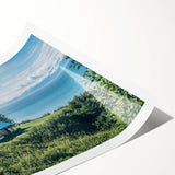 Serene countryside landscape wall art print showcasing rolling green hills, a clear blue sky, and a tranquil river, perfect for home decor enthusiasts.