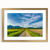 Elegant gold-framed wall art showcasing a serene countryside landscape, featuring lush greenery and rolling hills, ideal for home decor enhancement.