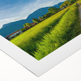 Vibrant rolled canvas depicting a serene countryside landscape with rolling hills and a colorful sunset, perfect for home decor and artistic enhancement.