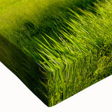 Close-up of a stretched canvas featuring a vibrant countryside landscape design, showcasing lush green fields and a serene sky, perfect for home decor.