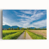 Stretched canvas wall art depicting a serene countryside landscape with rolling hills, vibrant green fields, and a clear blue sky, ideal for home decor enthusiasts.
