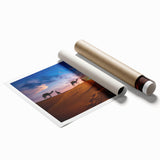 Desert landscape wall art print showcasing vibrant hues of orange and yellow, depicting sand dunes under a clear blue sky, rolled for easy framing and display.