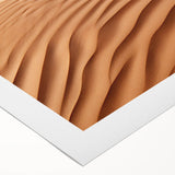 Vibrant rolled canvas artwork showcasing a desert landscape design with warm hues of orange and yellow, perfect for enhancing modern interior decor.