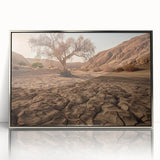 Framed acrylic wall art showcasing a serene desert landscape with warm tones of orange and gold, perfect for enhancing modern home decor. The sleek silver frame adds elegance to any setting, making it ideal for living rooms or offices.