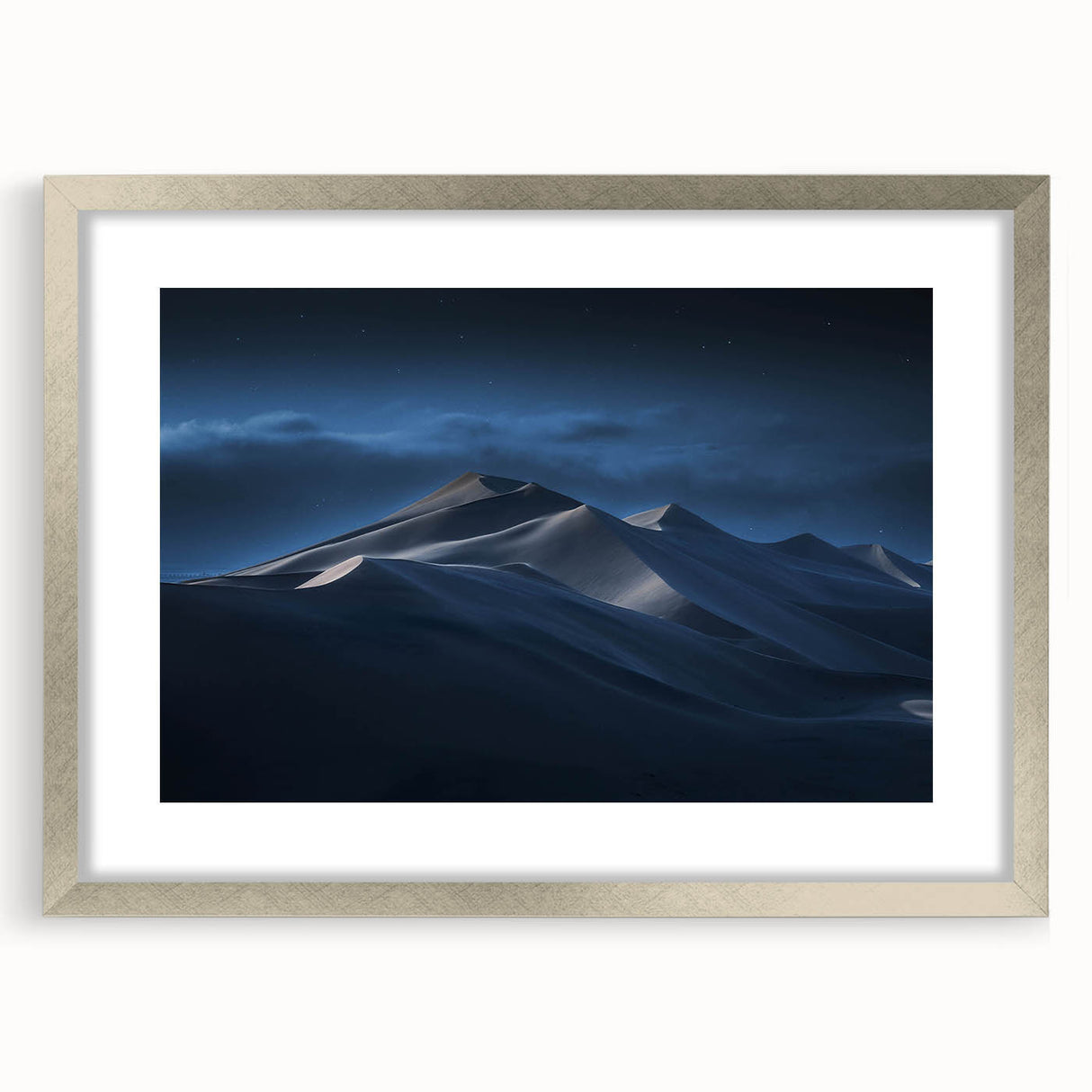 Framed wall art from the Dunes Design collection, showcasing serene desert landscapes in soft beige and gold tones, with a sleek silver frame and white matting.