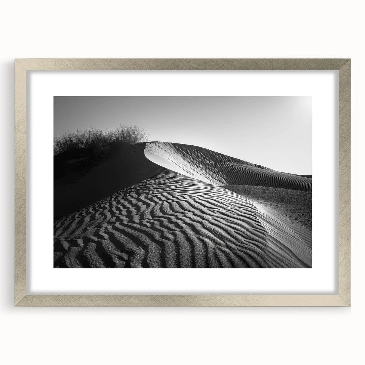 Framed wall art featuring a serene desert landscape with rolling dunes, presented in a sleek silver frame with a white mat, ideal for modern home decor.