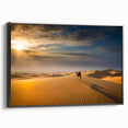 Framed canvas artwork showcasing a serene desert landscape with golden dunes and a blue sky, presented in a sleek black frame, ideal for modern home decor.