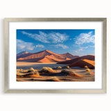 Framed landscape wall art featuring a serene sand dune design in soft beige and gold tones, elegantly matted and showcased in a sleek silver frame. Perfect for modern decor.