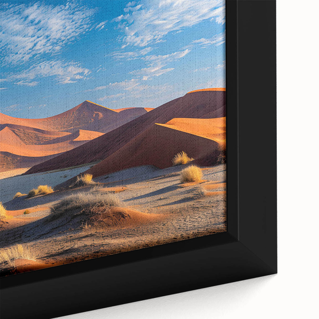 Close-up of a framed canvas wall art piece showcasing a vibrant desert dune landscape with warm hues of orange and gold, ideal for modern home decor.