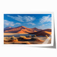 Stunning wall art print showcasing a serene landscape of golden sand dunes under a vibrant blue sky, ideal for home decor or office spaces.