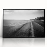 Framed acrylic wall art featuring a serene landscape of lush green fields under a clear blue sky, showcasing vibrant colors and depth with a sleek black frame. Perfect for modern home decor.