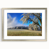 Framed wall art collection featuring a serene landscape of rolling fields, adorned with a sleek silver mat, perfect for enhancing home decor and adding a touch of elegance.